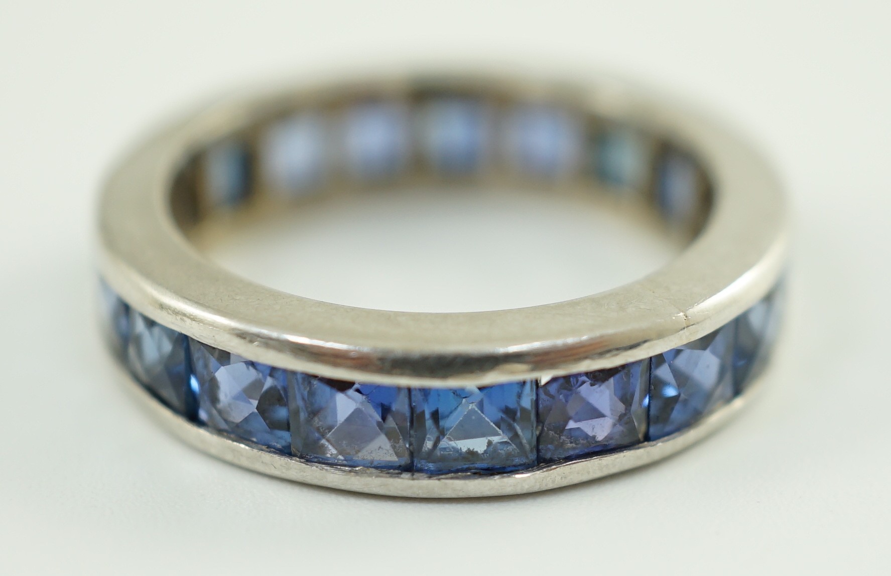 A platinum? and square cut sapphire set full eternity ring